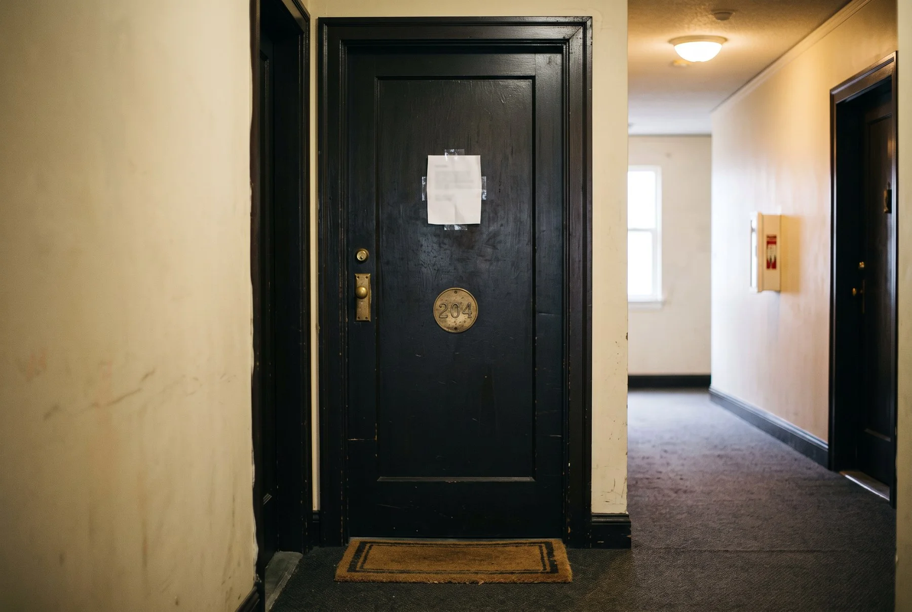 Apartment door with a paper notice taped to it